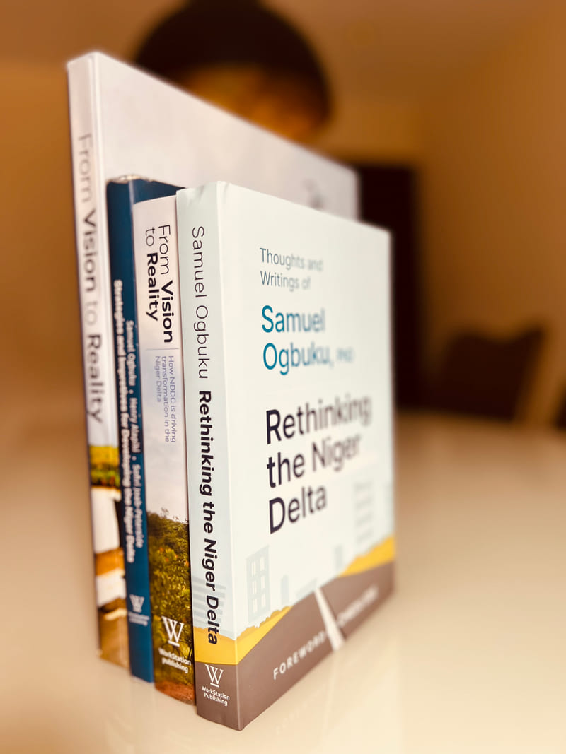 Books from the NDDC programme stacked upright, Rethinking the Niger Delta at the front.